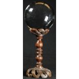 Mysticism - a 'crystal ball', turned, pierced and carved hardwood stand, 20cm high overall