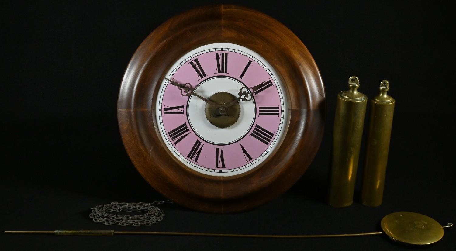 A 19th century postman's alarm clock, 17.5cm pink and white enamel dial inscribed with Roman