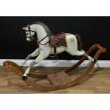 A good Edwardian dappled grey rocking horse on bow rockers, the carved, gesso and painted horse with