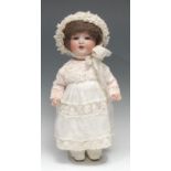 An Armand & Marseille (Germany) bisque head and painted composition bodied doll, brown wig on