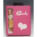 A vintage 1970's rectangular shaped pink vinyl Sindy carry case with single clothes hanger; a late