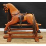 A 20th century House of Marbles (Devon) carved hardwood rocking horse on safety stand, carved