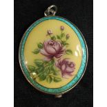 A large silver and enamel mirror locket