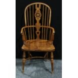 A 20th century Winsor elbow chair, hoop back, pierced wheel splat, bowed mid-rail terminating in