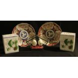 A pair of Japanese Imari porcelain dishes, Meiji period; a pair of Chinese pillow headrests; a