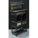 An Aesthetic period ebonised side cabinet, half gallery with small shelf above a bevelled