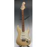 A Fender Stratocaster electric guitar, USA honey blonde, maple neck, rosewood finger board. Serial