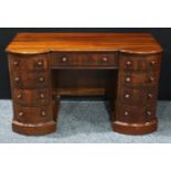 A Victorian design mahogany kneehole desk, slightly oversailing top above a central frieze drawer,