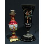 A 19th century oil lamp base, in terracotta with a vitreous black glaze, enamelled with a bird