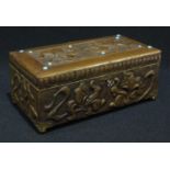 An Art Nouveau brass rectangular table casket, the hinged cover applied with blue glass cabochons,