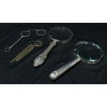 A silver hafted magnifying glass; another, plated haft; a pair of lorgnettes; a connoisseur's