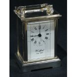 A Woodford silver plated carriage clock, white dial, Roman numerals, swing handle, 15cm, battery