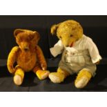 A 20th century straw filled golden plush mohair teddy bear with growler, amber and black glass eyes,