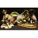 An Italian resin model of rearing stallions, oval wooden plinth base, 32.5cm high 37cm wide; a