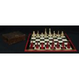 A 19th century carved and stained bone part chess set, a chess board