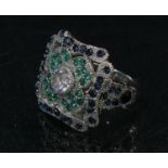 An Art Deco style shaped square base metal dress ring, set with an arrangement of clear, blue and