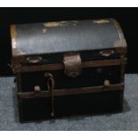 An early 20th century copper mounted dome top travelling luggage trunk, bearing fragmentary travel