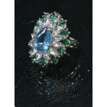 An Art Deco style base metal flower head cluster ring, set with an arrangement of clear, blue and