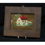 A Victorian woolwork picture of a cottage, Home Sweet Home, 20.5cm x 25.5cm overall