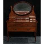 An Edwardian crossbanded mahogany dressing table, oval mirrored back flanked by two small drawers,