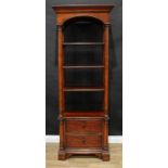 An American Thomasville room centre or pier open display cabinet, outswept cornice with arched apron