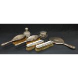 A George V seven piece matched dressing table set, comprising of hand mirror, brushes, cut glass and