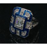 An Art Deco style base metal rectangular dress ring, clear glass and blue enamel, ring size N, boxed