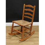 A 19th century Lancashire elm ladder back rush seated rocking chair
