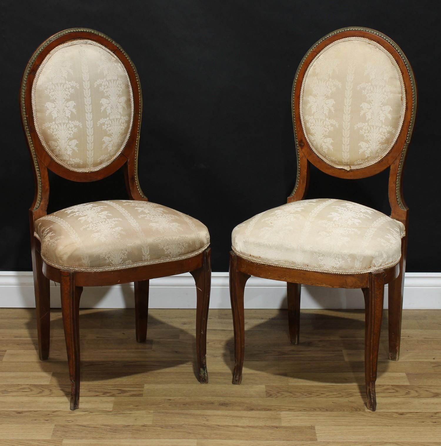 A pair of Louis XVI Revival gilt metal mounted side chairs, stuffed over upholstery, 95cm high, 46cm