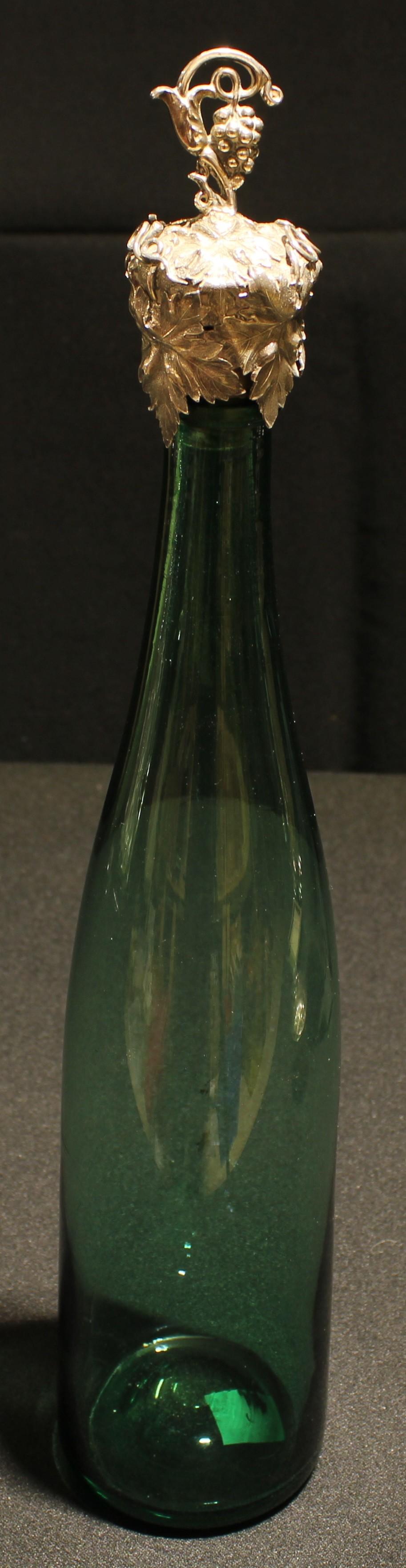 An early Victorian silver mounted emerald glass slender mallet shaped decanter, fruiting vine