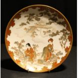 A Japanese satsuma circular plate, decorated with young girls picking tea, 24cm diam, eight charcter