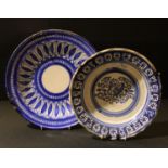 A 19th century Islamic blue and white plate, 31cm diameter; another similar, 27cm diameter (2)