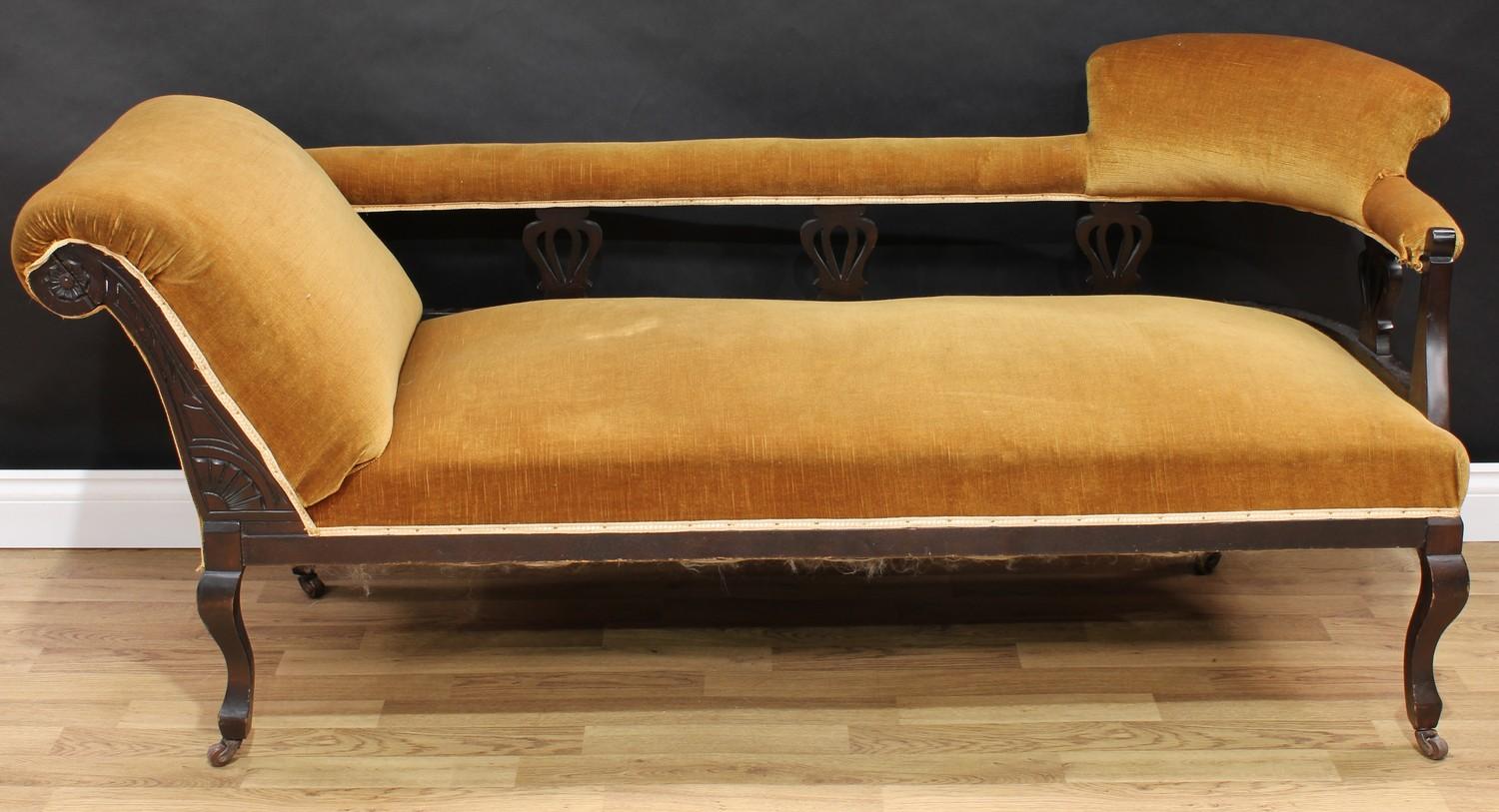 An Edwardian chaise longue or day bed, curved cresting rail to support a formally seated