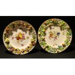 A matched pair of German porcelain shaped circular basket plates, possibly Wallendorfer, painted