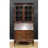 An Arts and Crafts oak bureau bookcase, copper hinges, 200.5cm high, 100cm wide, 46.5cm deep,