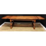 A 17th century style oak extending refectory type trestle dining table, rectangular top with two