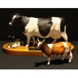 A Beswick Connoisseur Model of a Friesian Cow and Calf, matt finish, mounted on wooden base, 34cm