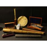 A brass three draw telescope, 28cm; a set of brass measuring instruments, treen rulers by WH Harling