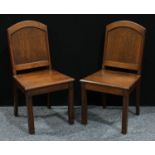 A pair of early 20th century oak hall chairs, arched panel backs, square legs, 92cm high (2)