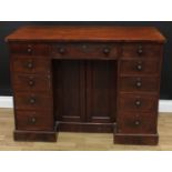 A Victorian mahogany kneehole desk, oversailing rectangular top above three frieze drawers, a pair