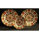 A pair of Royal Crown Derby 1128 pattern plates, 21.5cm diameter; another, 16cm plate; all first