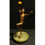 An Art Deco model, as a female nude holding aloft a tiger eye ball, onyx base, 38.5cm high