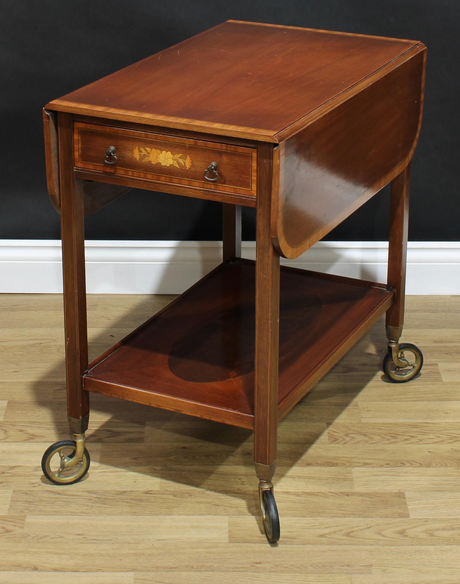 A Sheraton Revival style satinwood crossbanded mahogany and marquetry butler's trolley, rounded