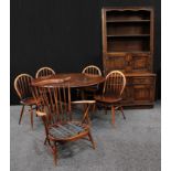 A retro mid-20th century drop-leaf dining table and chairs, probably Ercol, the table 72cm high,