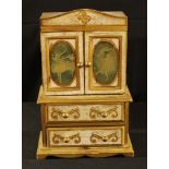 A painted and gilt musical dressing table jewellery cabinet, serpentine cresting above a pair of