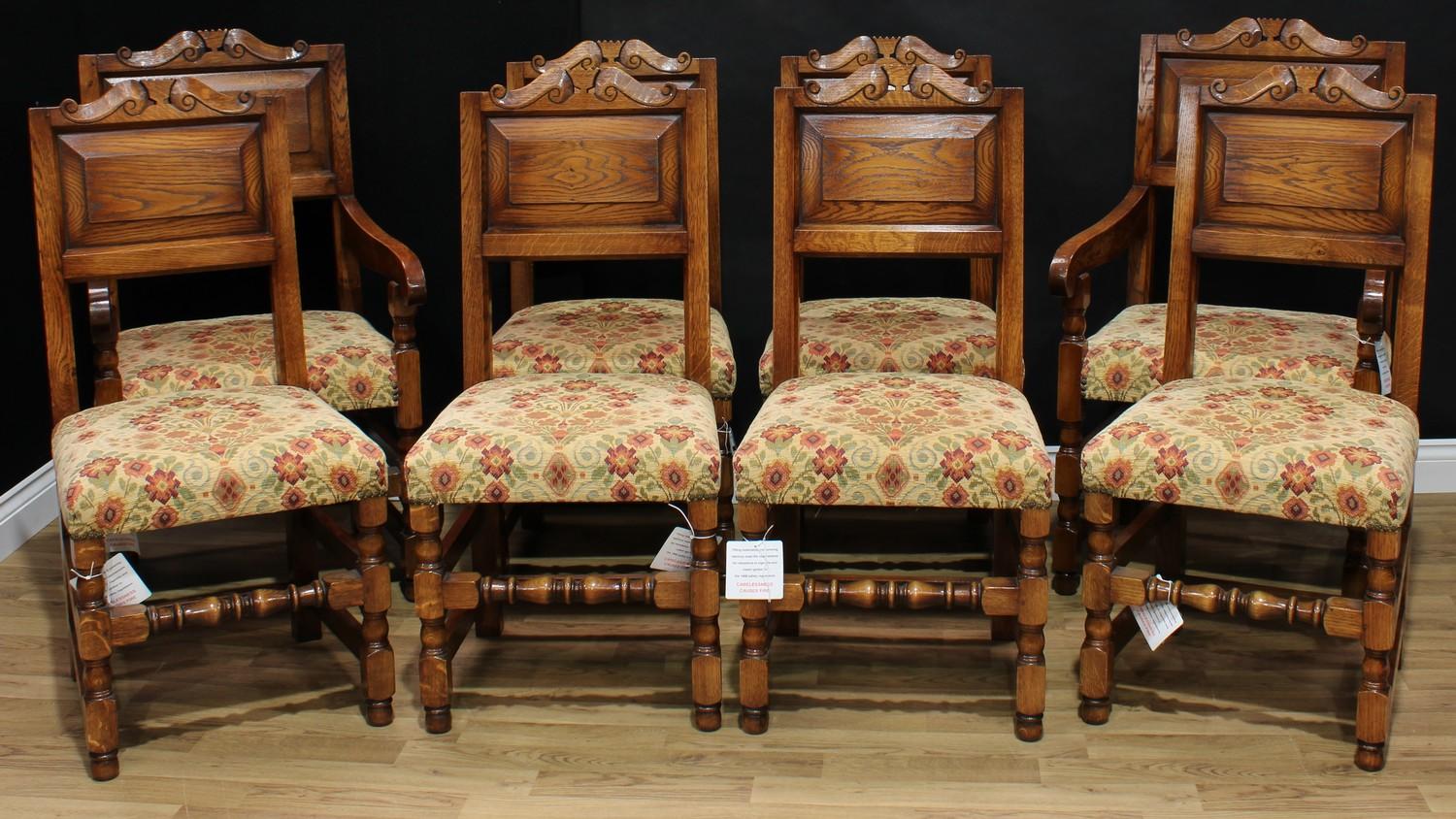 A set of eight 17th century style oak dining chairs, comprising six side chairs and a pair of