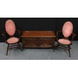 A Charles II style oak blanket chest, hinged top above a two panel front applied with geometric