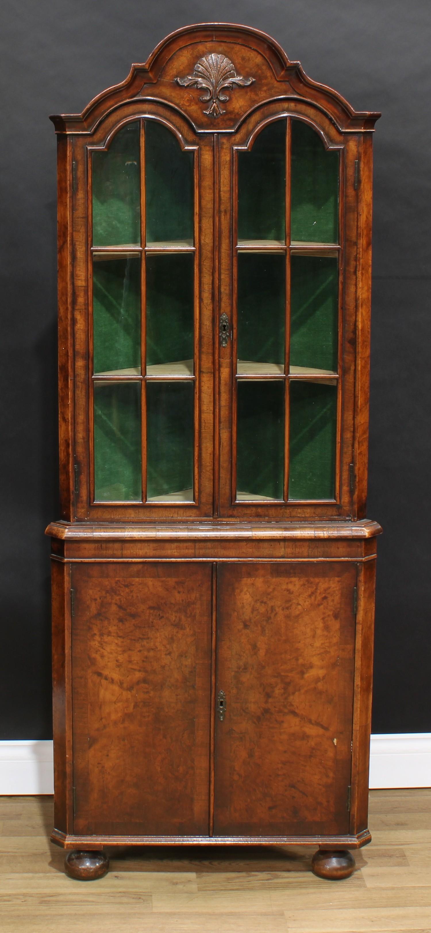 A George I style mahogany crossbanded walnut veneer floor standing corner display cabinet, of