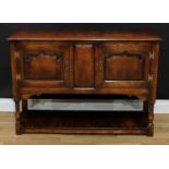 A George III style oak side cabinet, oversailing moulded rectangular top above a pair of arched