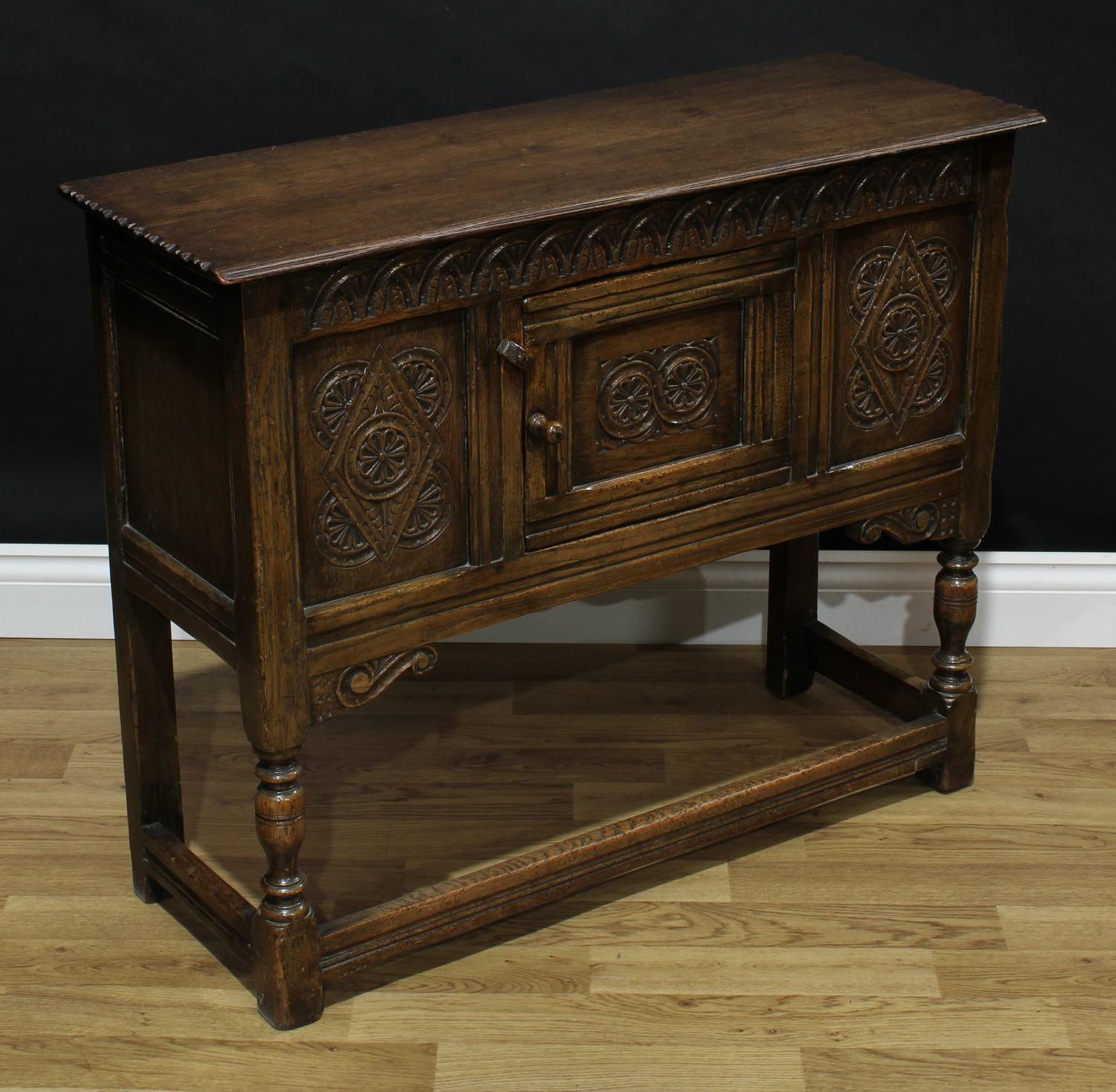 A 17th century style oak low side cabinet, oversailing rectangular top above a central panel door, - Bild 2 aus 2